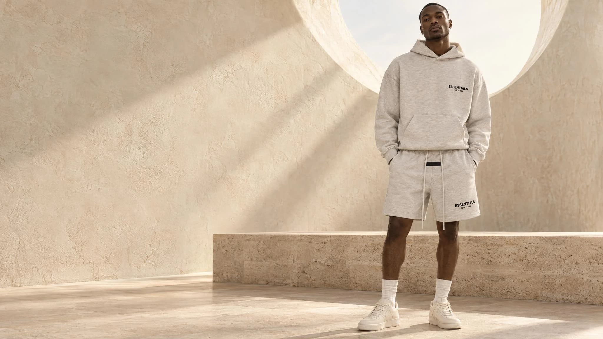 Yenoto AI campaign featuring a light oatmeal Essentials hoodie and shorts